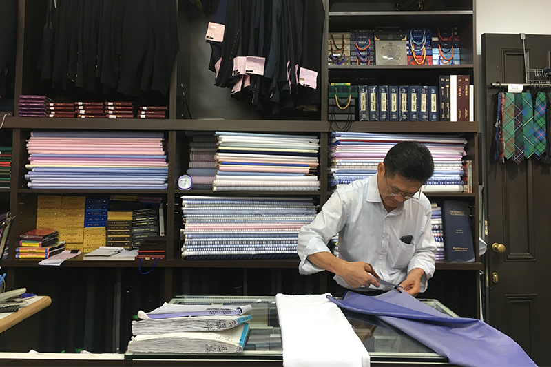 Yuen's Tailor's Yuen brother making a suit