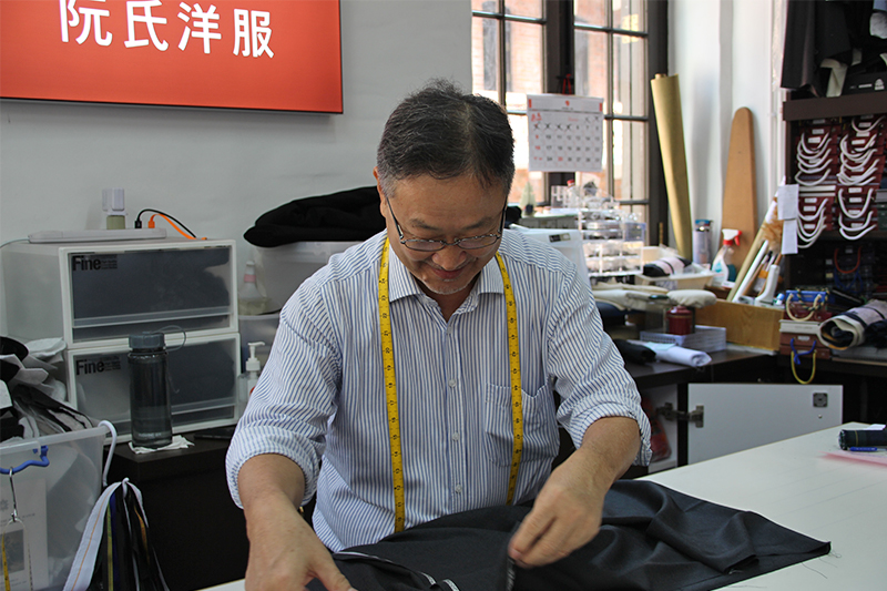 Yuen's Tailor's Yuen brother demonstrating how to make a suit