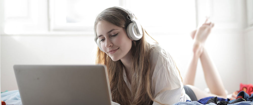 Girl with Headphones and Laptop
