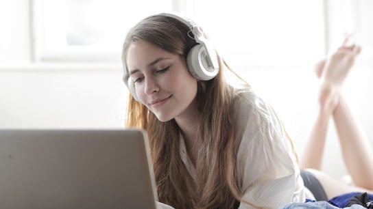 Girl with Headphones and Laptop