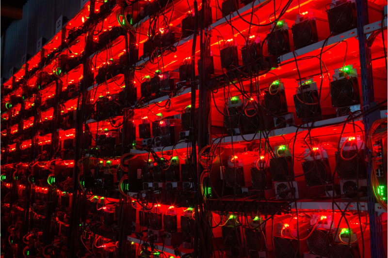 image of cryptocurrency mining facility dark with glowing red light