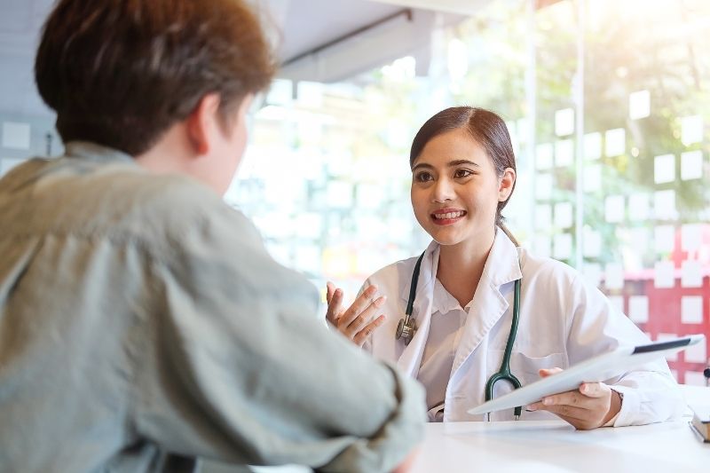 Asian Woman talking to patients 