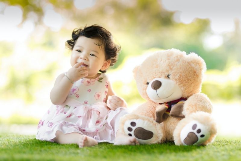 Baby girl and teddy bear