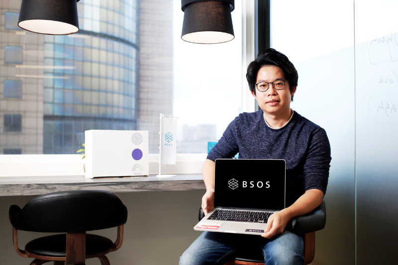 asian man with laptop, bsos logo