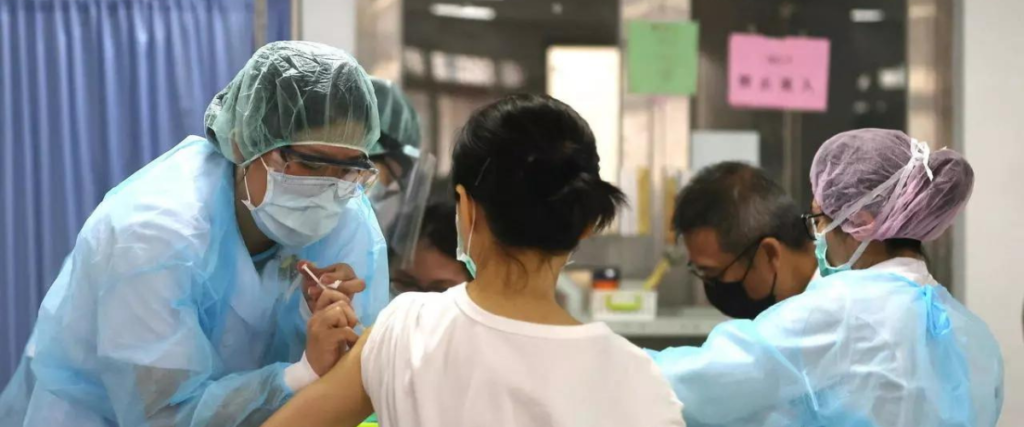 taiwan vaccination drive medical worker in ppe giving vaccine to woman