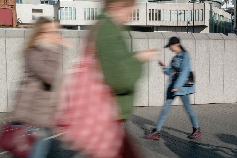People walking and using phones_increased broadband